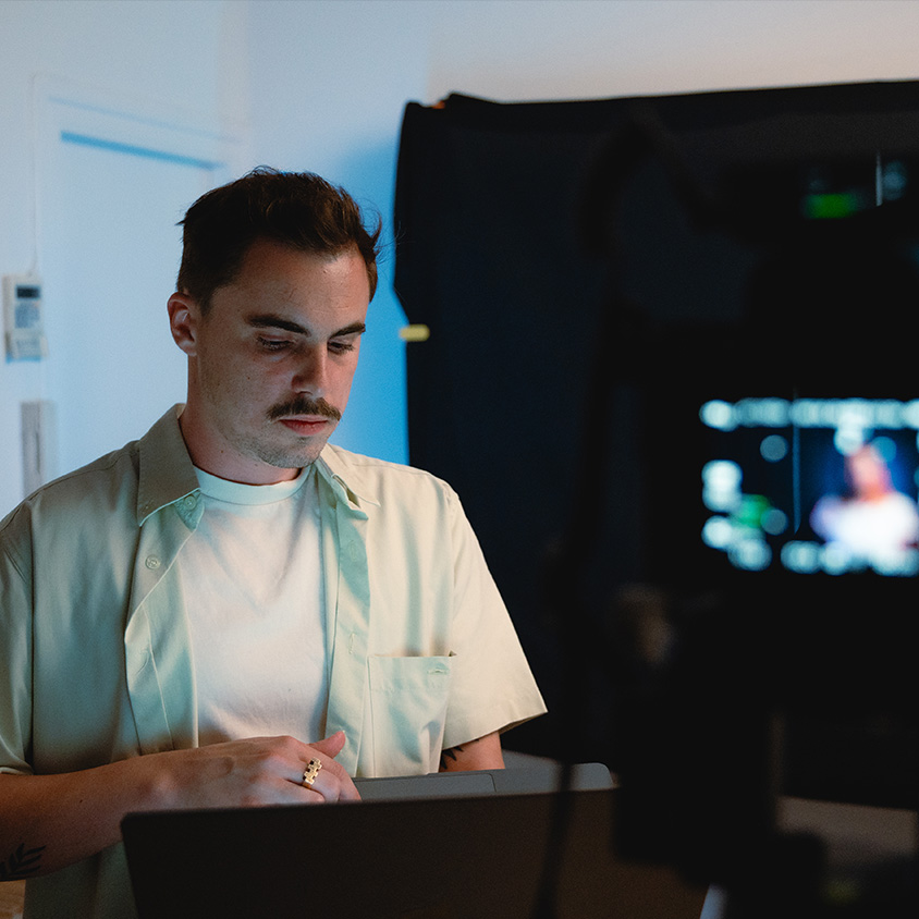 Making of captation vidéo de léquipe devant l'ordinateur dans les studios avec la caméra au premier plan